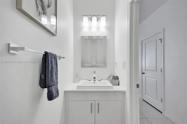 a bathroom with a sink vanity and mirror