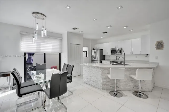 a large kitchen with a table and chairs