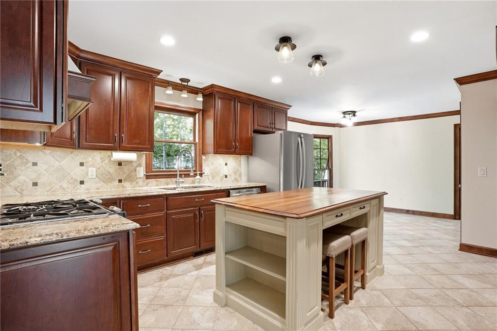 210 Woodrill Way Atlanta, GA 30350 - Photo 12 of 34 a kitchen with granite countertop a sink stove and cabinets