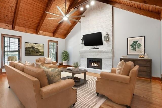 210 Woodrill Way Atlanta, GA 30350 - Photo 13 of 34 a living room with furniture a fireplace and a flat screen tv