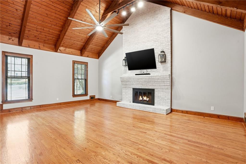 210 Woodrill Way Atlanta, GA 30350 - Photo 14 of 34 a view of empty room with wooden floor and fireplace