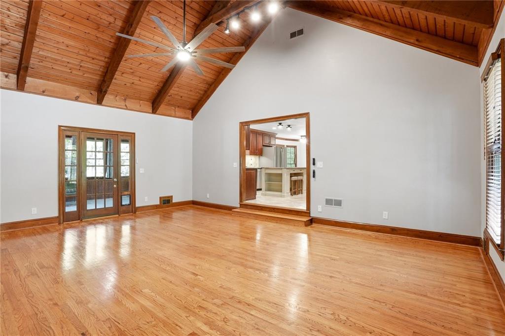 210 Woodrill Way Atlanta, GA 30350 - Photo 15 of 34 a view of an empty room with wooden floor and a window
