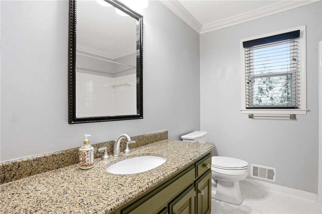 210 Woodrill Way Atlanta, GA 30350 - Photo 22 of 34 a bathroom with a granite countertop toilet a sink and a mirror