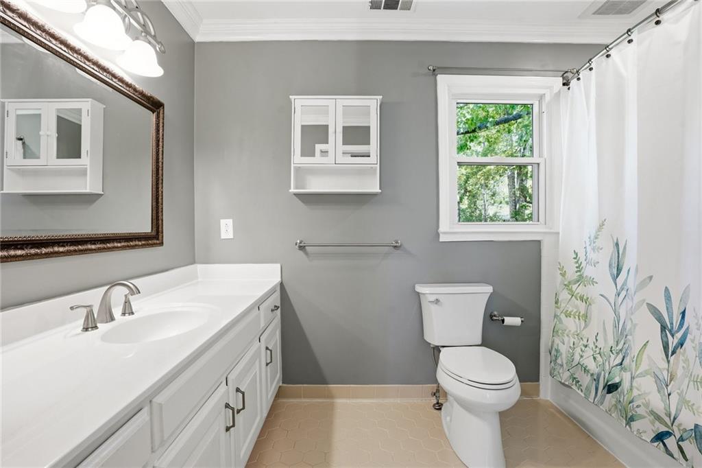 210 Woodrill Way Atlanta, GA 30350 - Photo 25 of 34 a bathroom with a sink a toilet and a mirror