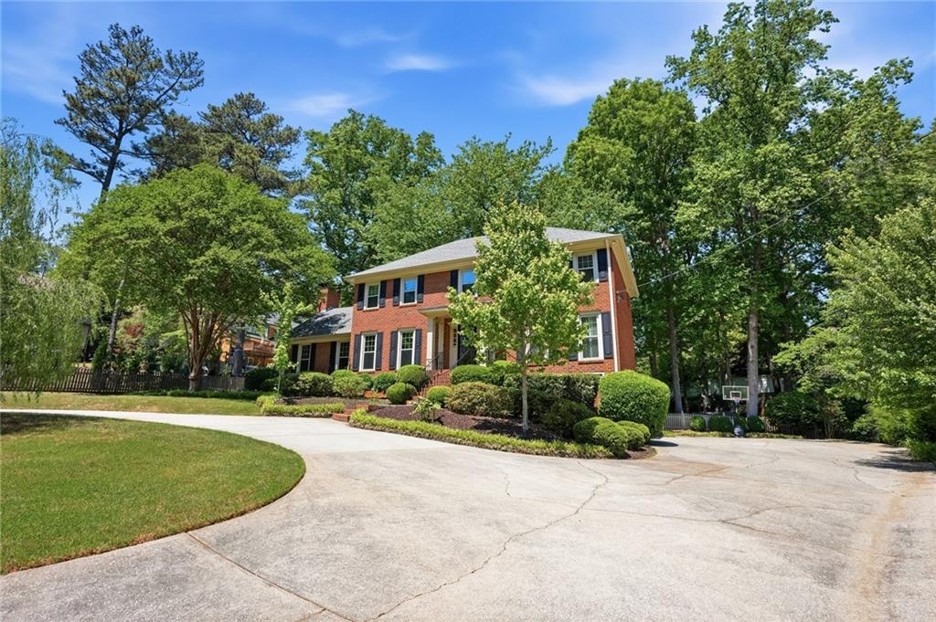 210 Woodrill Way Atlanta, GA 30350 - Photo 3 of 34 a front view of a house with a garden