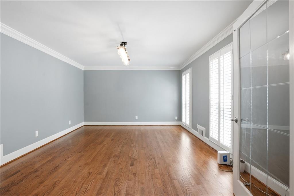 210 Woodrill Way Atlanta, GA 30350 - Photo 9 of 34 wooden floor in an empty room with a window