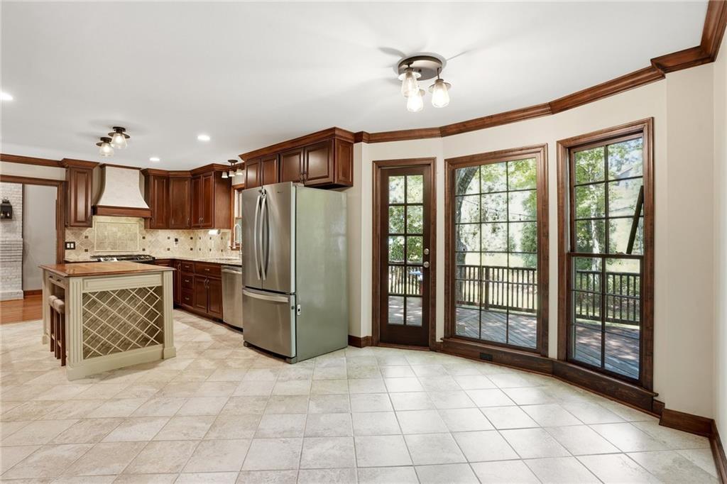 210 Woodrill Way Atlanta, GA 30350 - Photo 10 of 34 a kitchen with stainless steel appliances granite countertop a refrigerator and a sink
