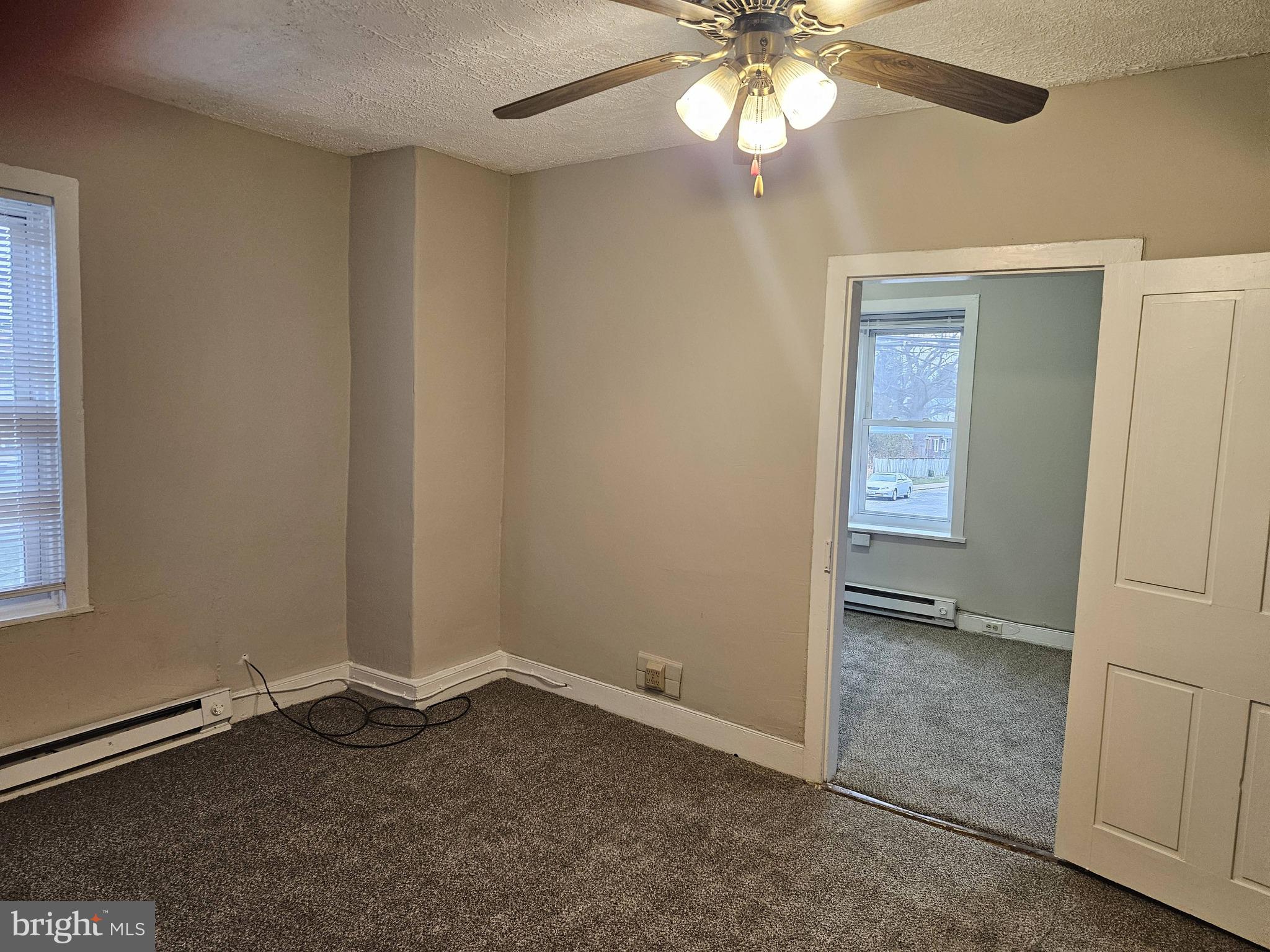 10 East Frederick Street, Unit 10B Walkersville, MD 21793 - Photo 8 of 18 Family Room with ceiling fan and new carpet