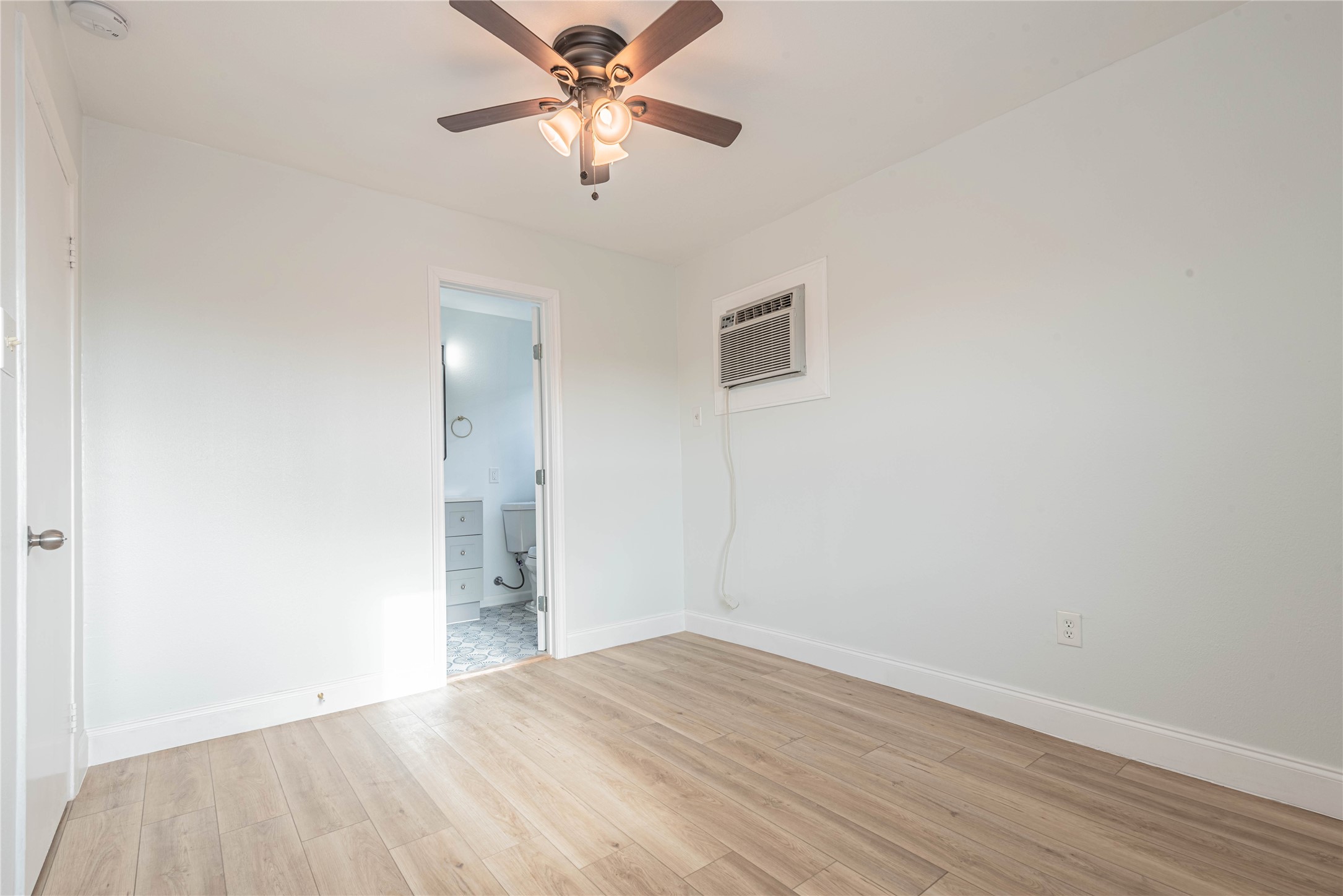 2303 Rosewood Street, Unit 6 Houston, TX 77004 - Photo 12 of 15 wooden floor in an empty room with a window