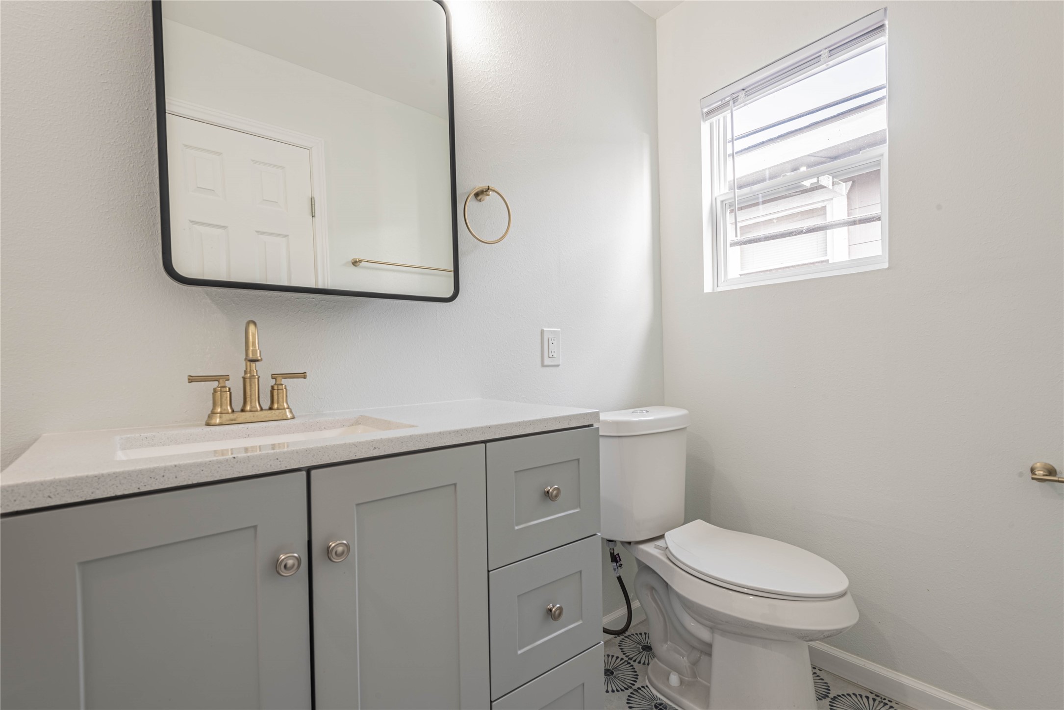 2303 Rosewood Street, Unit 6 Houston, TX 77004 - Photo 14 of 15 a bathroom with a toilet sink vanity and mirror