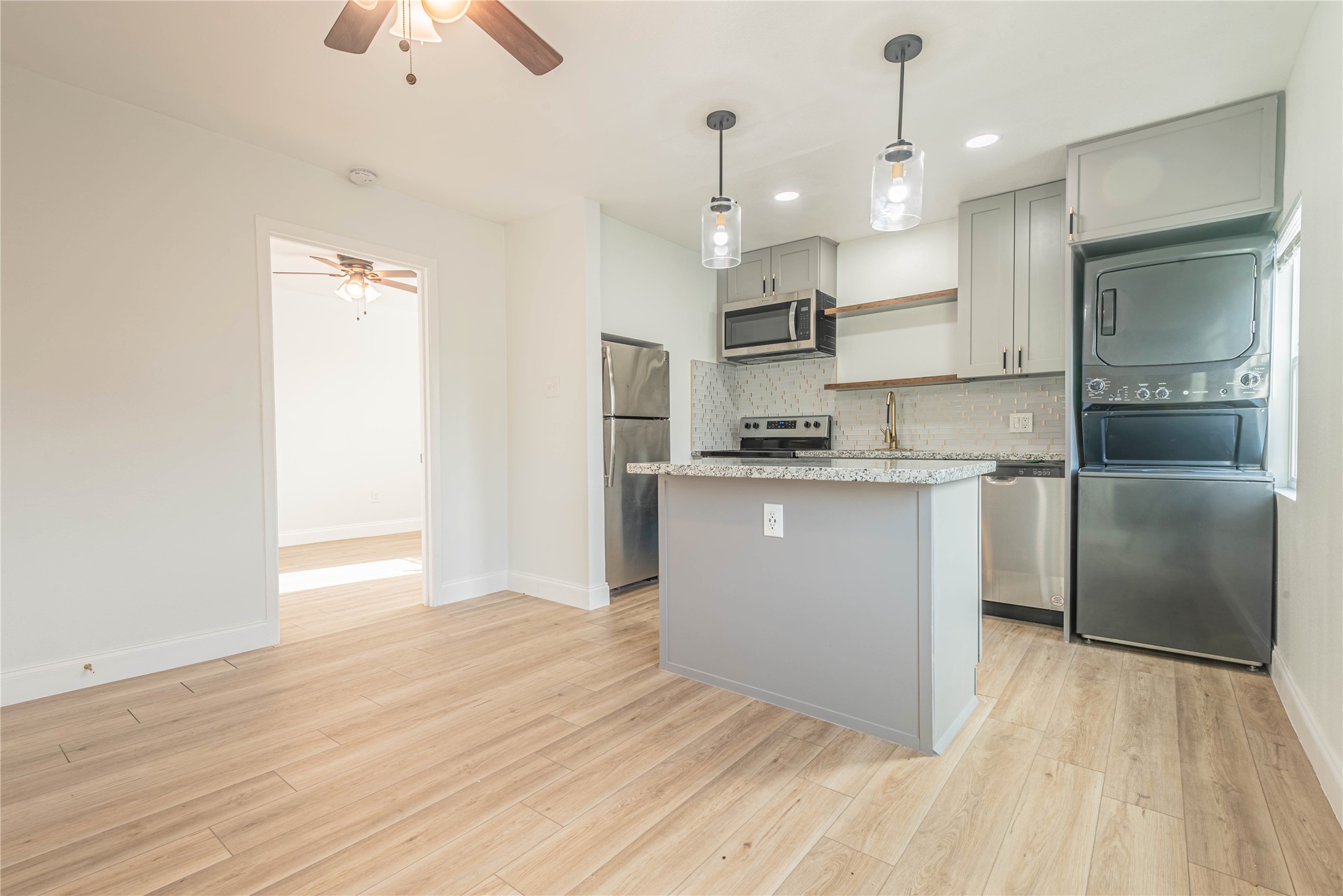 2303 Rosewood Street, Unit 6 Houston, TX 77004 - Photo 6 of 15 a kitchen with stainless steel appliances granite countertop a refrigerator a sink a stove and a oven