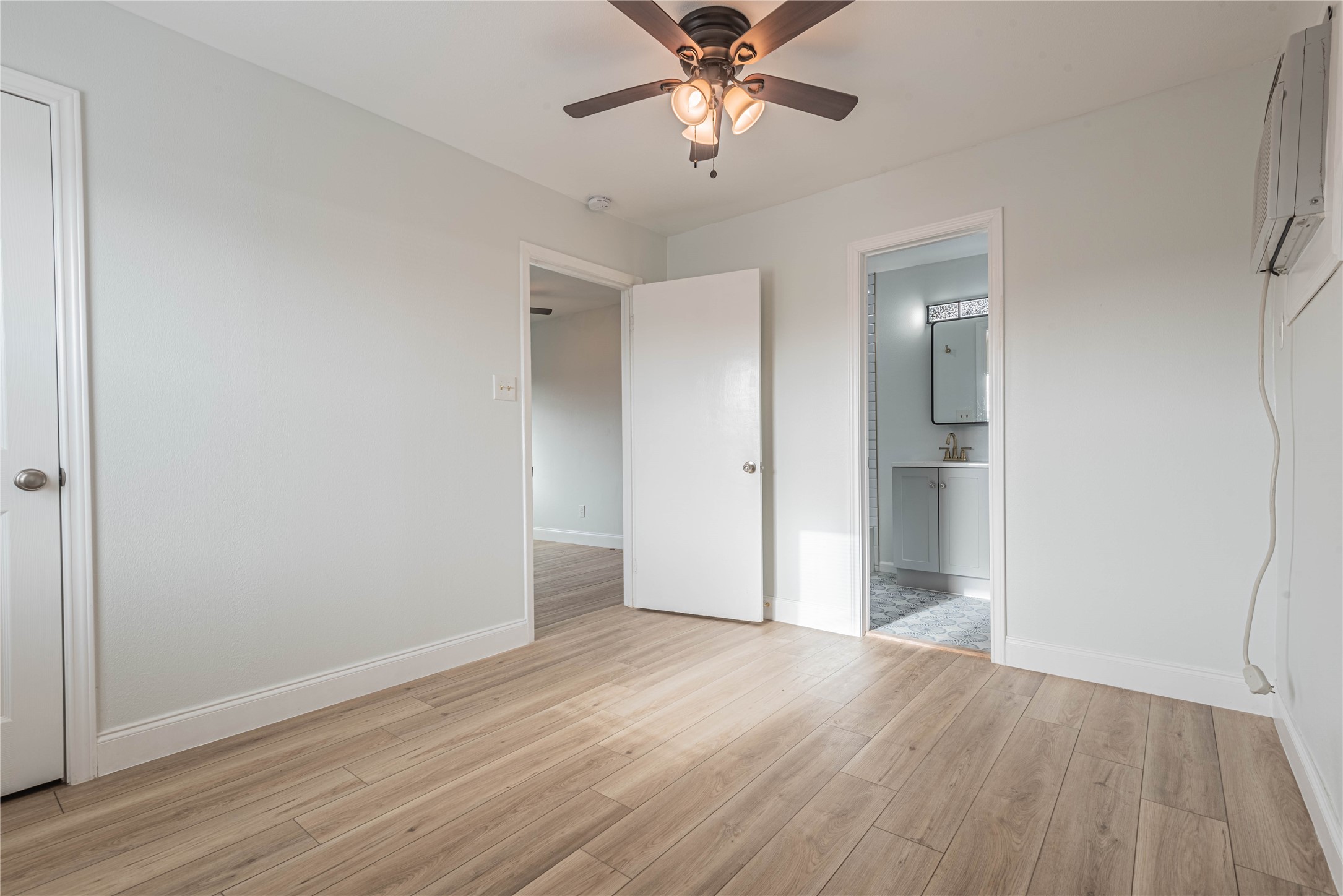 2303 Rosewood Street, Unit 6 Houston, TX 77004 - Photo 9 of 15 an empty room with wooden floor and door