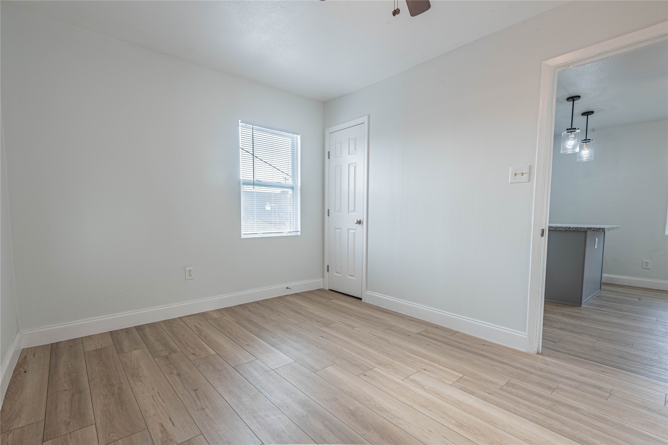 2303 Rosewood Street, Unit 6 Houston, TX 77004 - Photo 10 of 15 a view of an empty room with wooden floor and a window