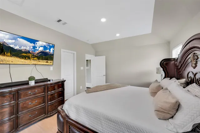 a bedroom with a bed and a flat screen tv