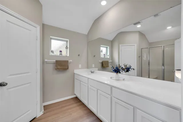 a spacious bathroom with a double vanity sink and mirror