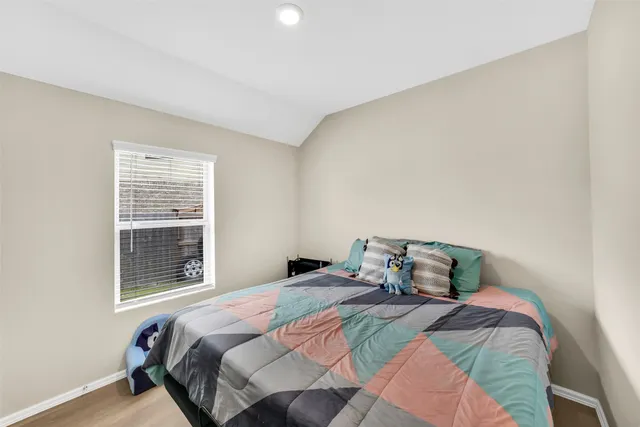 a bedroom with a bed and window