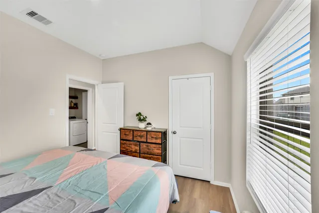 a bedroom with a bed and a window