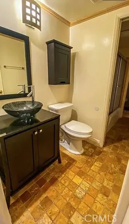 a bathroom with a sink toilet and mirror