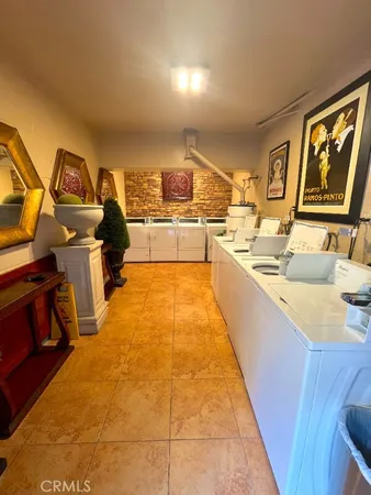 a large kitchen with stainless steel appliances a stove a sink dishwasher and cabinets