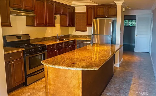a kitchen with stainless steel appliances granite countertop a sink and a stove