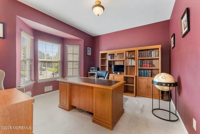 a living room with furniture a rug and a large window