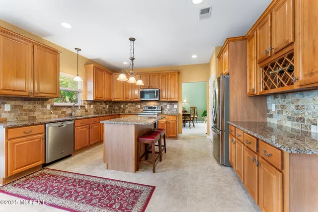 a kitchen with a sink refrigerator and cabinets