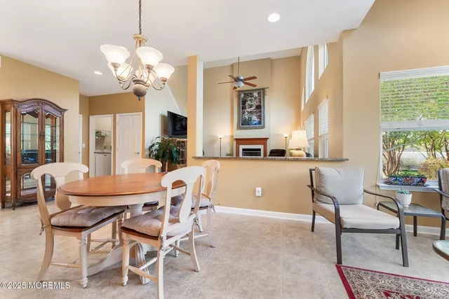 a view of a dining room with furniture a chandelier and wooden floor