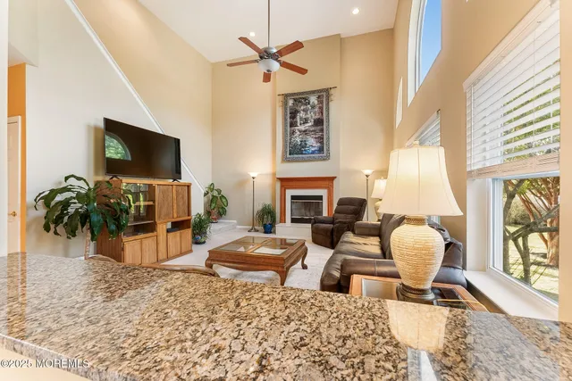 a living room with furniture a fireplace and a flat screen tv