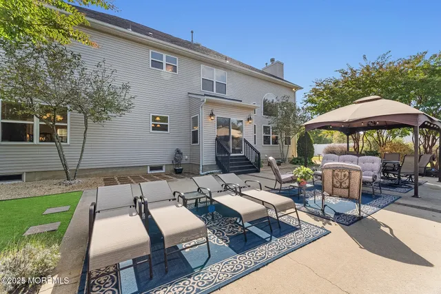 a view of backyard of house with seating space