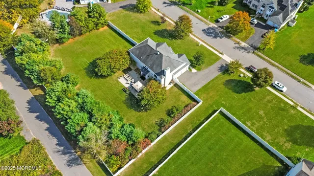 an aerial view of a residential houses with outdoor space