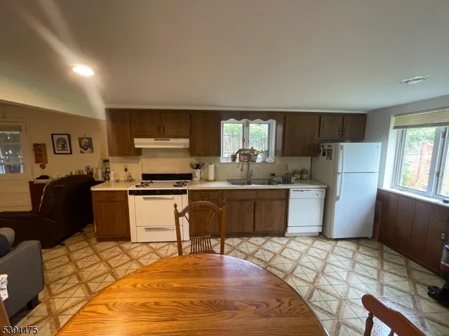 a kitchen with a refrigerator and a stove top oven