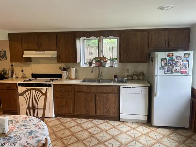 a kitchen with stainless steel appliances granite countertop a refrigerator sink and cabinets