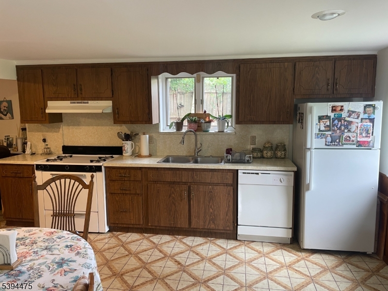 192 West Mt Pleasant Avenue, Unit 1 Livingston, NJ 07039 - Photo 6 of 10 a kitchen with stainless steel appliances granite countertop a refrigerator sink and cabinets
