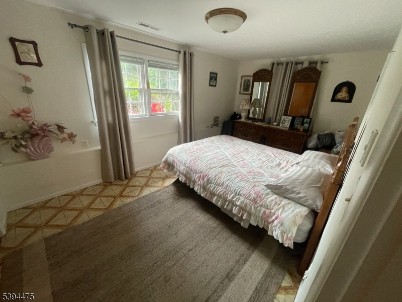 192 West Mt Pleasant Avenue, Unit 1 Livingston, NJ 07039 - Photo 7 of 10 a bedroom with a bed and wooden floor