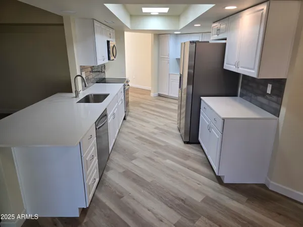 a kitchen that has a sink and a stove in it