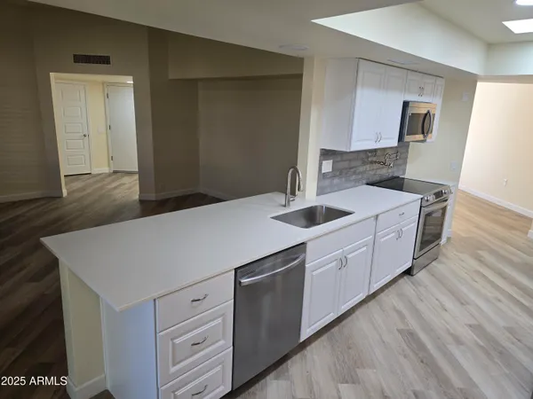a view of kitchen with white cabinets