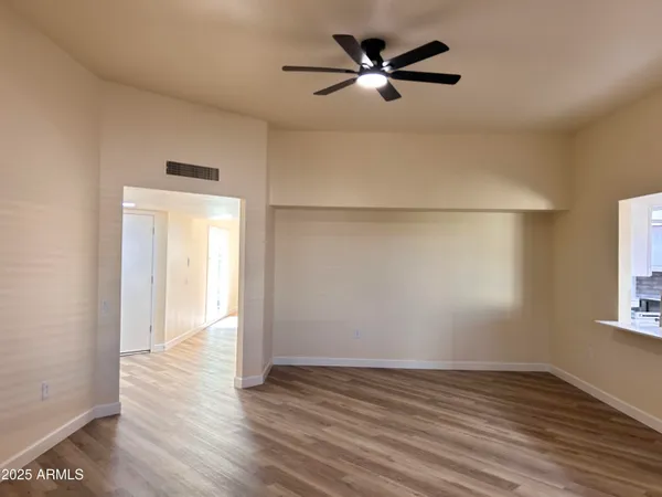 wooden floor in an empty room with a window