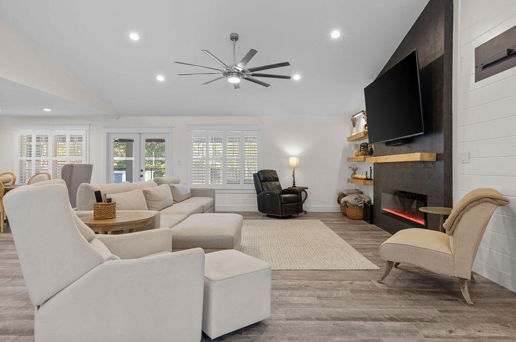 442 Shipwreck Road Santa Rosa Beach, FL 32459 - Photo 30 of 103 a living room with furniture a fireplace and a flat screen tv