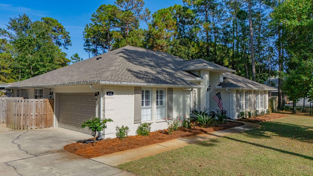 442 Shipwreck Road Santa Rosa Beach, FL 32459 - Photo 3 of 103 a front view of a house with a yard and potted plants