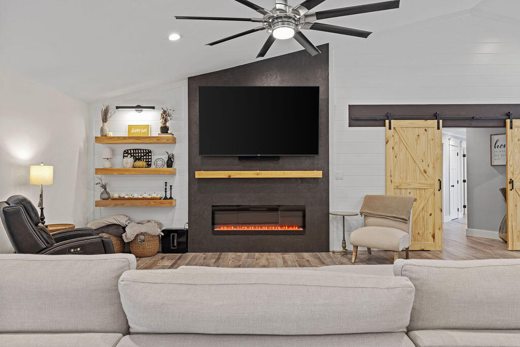 442 Shipwreck Road Santa Rosa Beach, FL 32459 - Photo 32 of 103 a living room with furniture a flat screen tv and a fireplace