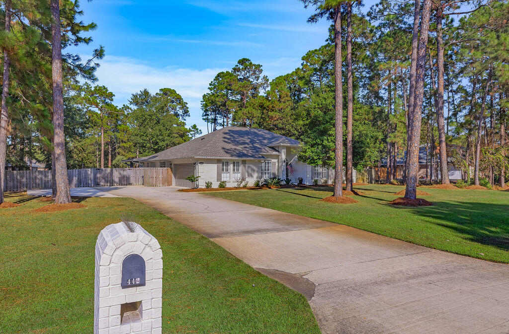 442 Shipwreck Road Santa Rosa Beach, FL 32459 - Photo 4 of 103 a front view of a house with a yard and large tree