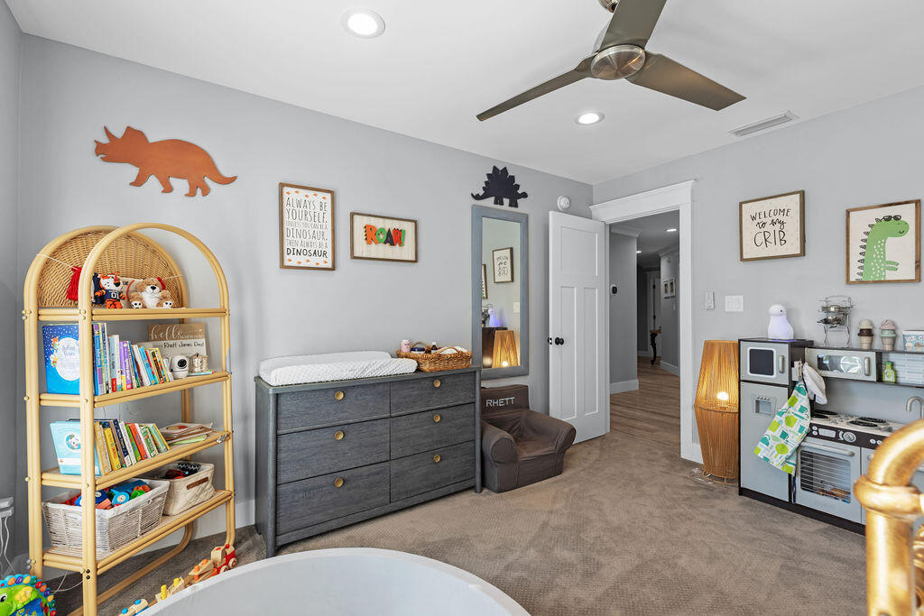 442 Shipwreck Road Santa Rosa Beach, FL 32459 - Photo 59 of 103 a living room with furniture a rug and a bookshelf