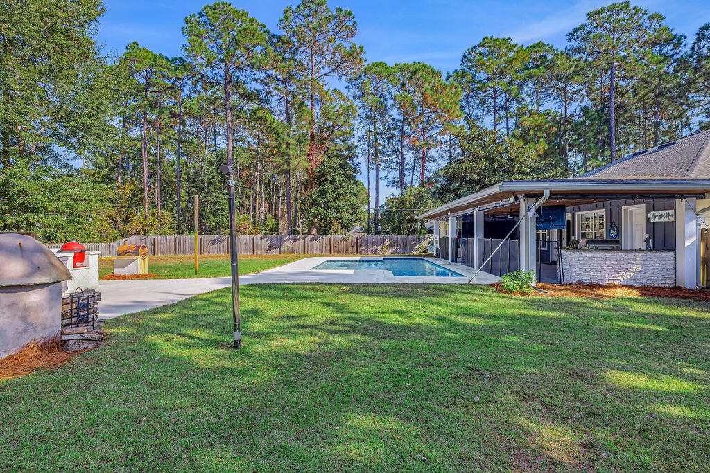 442 Shipwreck Road Santa Rosa Beach, FL 32459 - Photo 6 of 103 a view of a house with a backyard and a patio