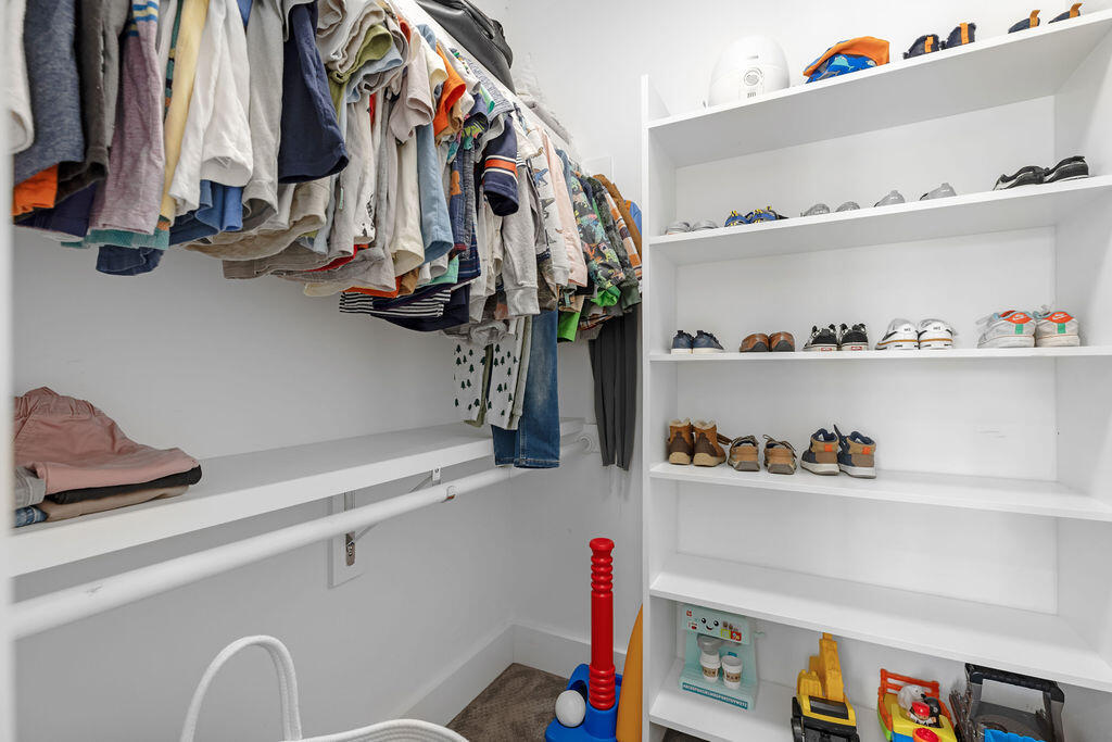 442 Shipwreck Road Santa Rosa Beach, FL 32459 - Photo 62 of 103 a view of walk in closet with clothes and shoes
