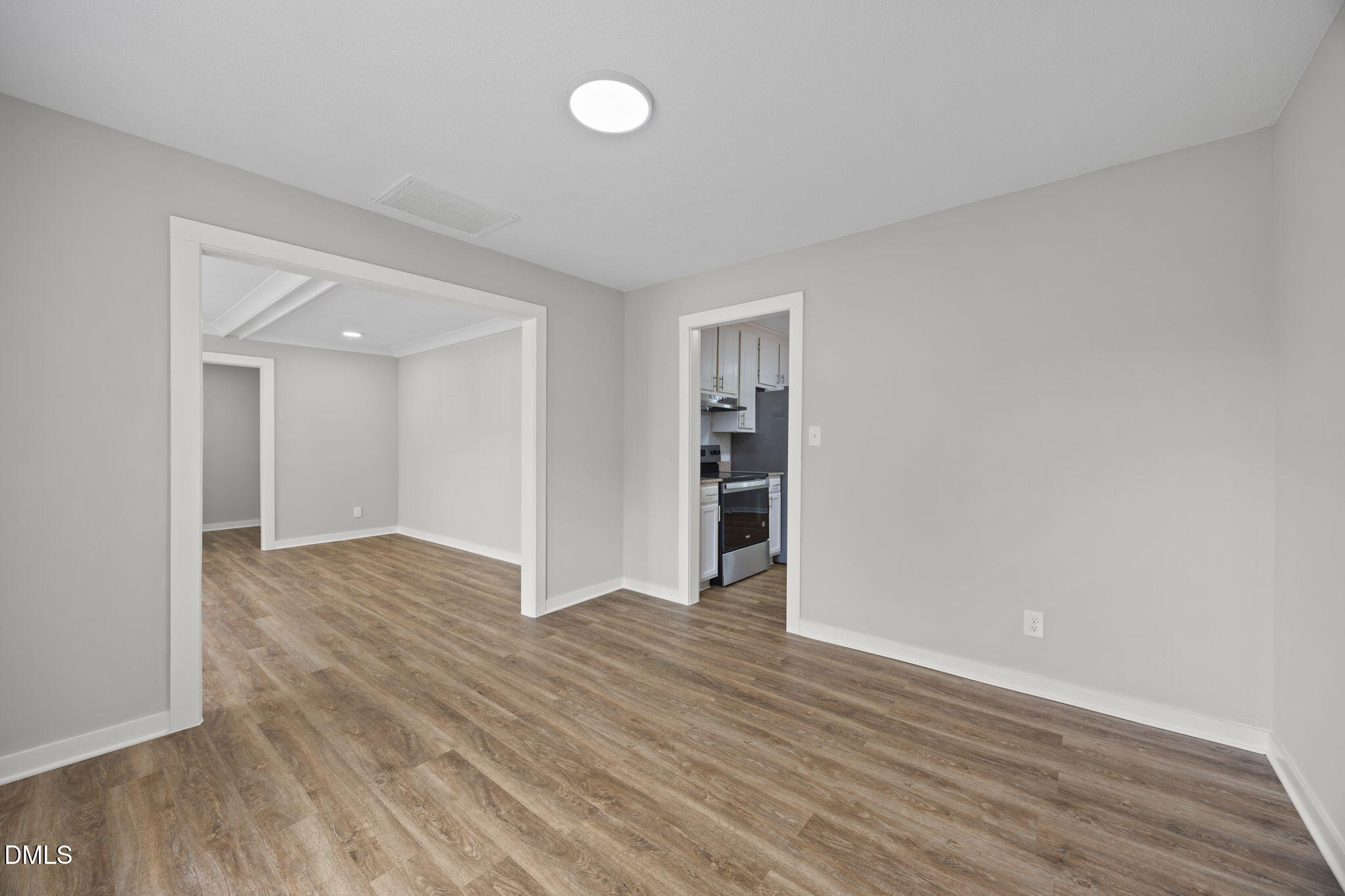 309 Rippling Stream Road Durham, NC 27704 - Photo 13 of 45 a view of an empty room with wooden floor and closet