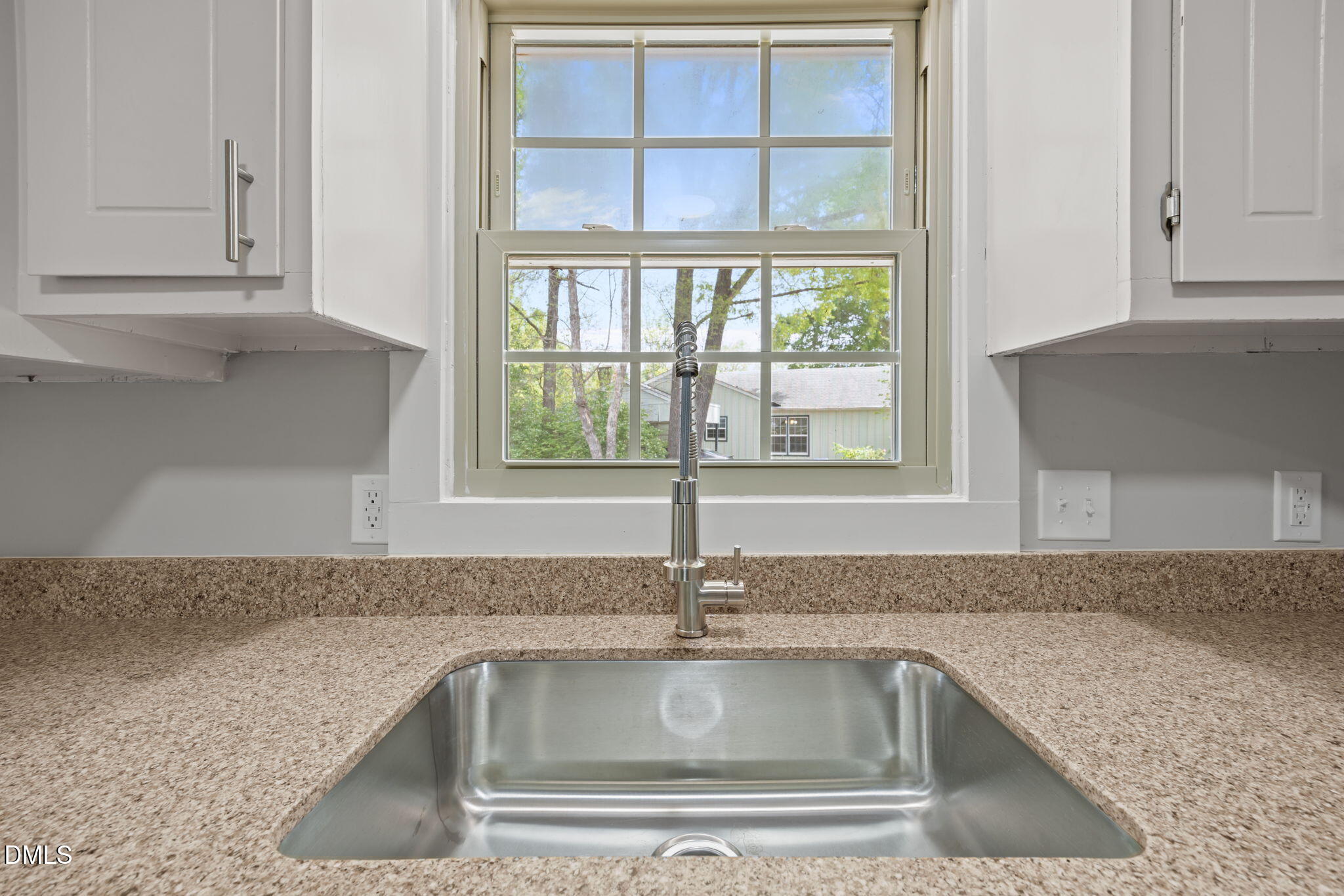 309 Rippling Stream Road Durham, NC 27704 - Photo 15 of 45 a kitchen with granite countertop a sink and a window
