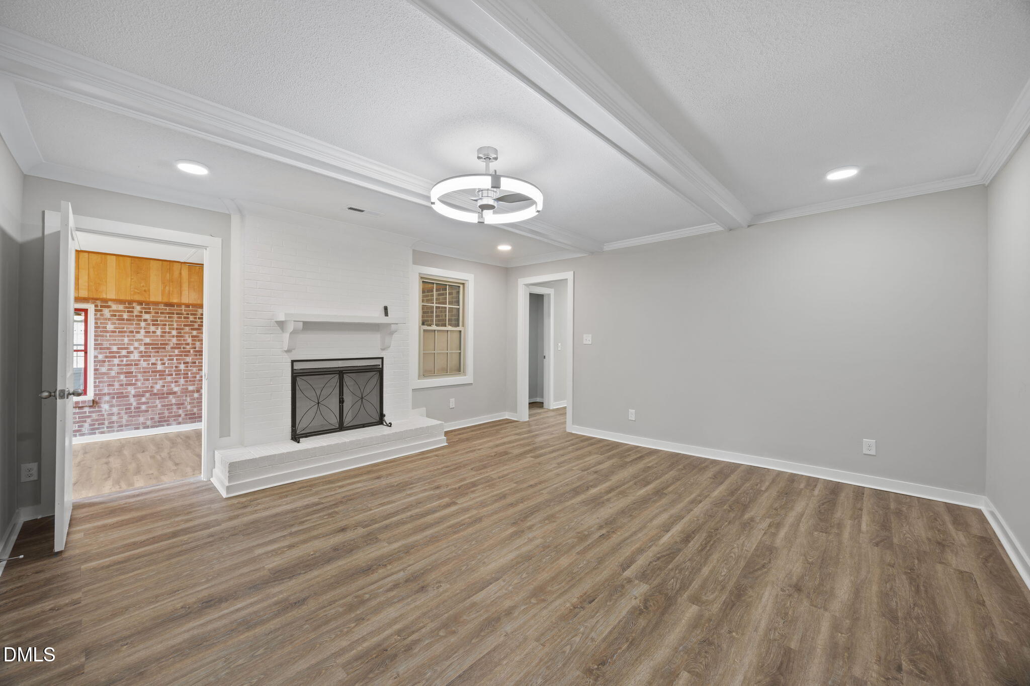 309 Rippling Stream Road Durham, NC 27704 - Photo 20 of 45 wooden floor in an empty room with a fireplace