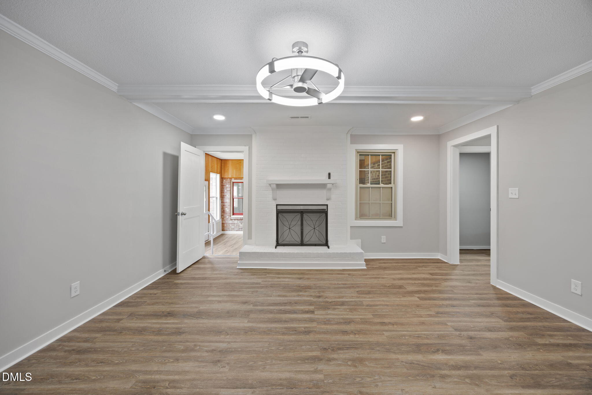 309 Rippling Stream Road Durham, NC 27704 - Photo 21 of 45 a view of an empty room with wooden floor fireplace and a window