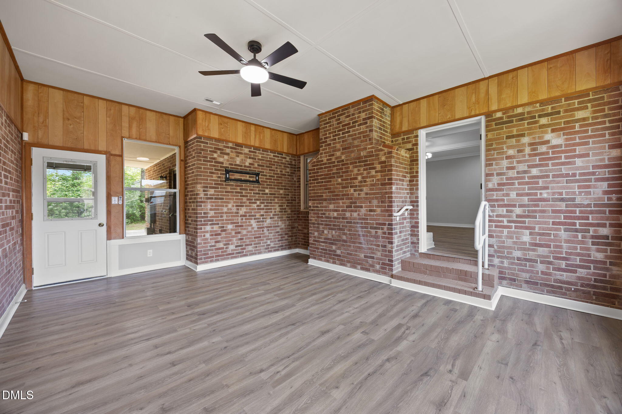 309 Rippling Stream Road Durham, NC 27704 - Photo 22 of 45 a view of an empty room with wooden floor and a window
