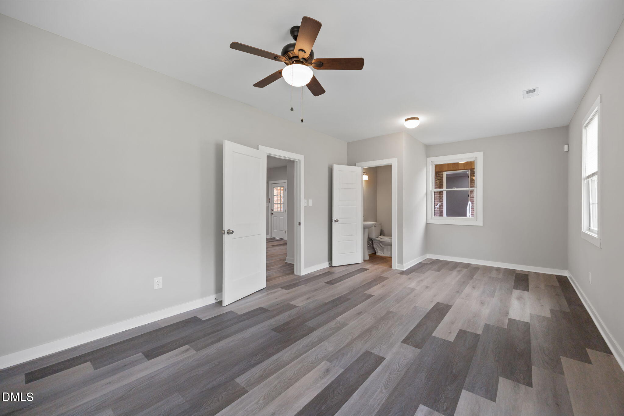 309 Rippling Stream Road Durham, NC 27704 - Photo 25 of 45 an empty room with wooden floor ceiling fan and windows